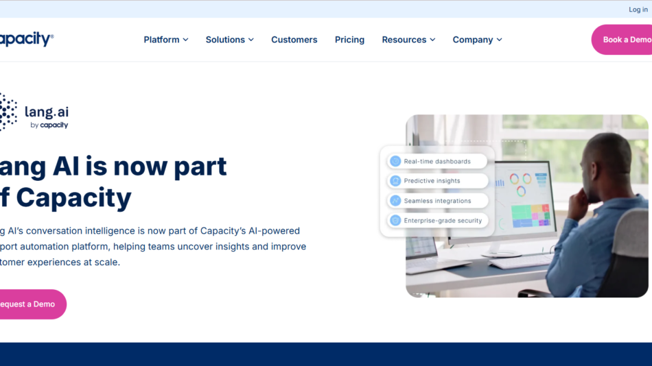 Announcement that Lang AI is now part of Capacity; Lang AI logo on the left with a person at a computer displaying dashboards on the right in a modern web header hero.