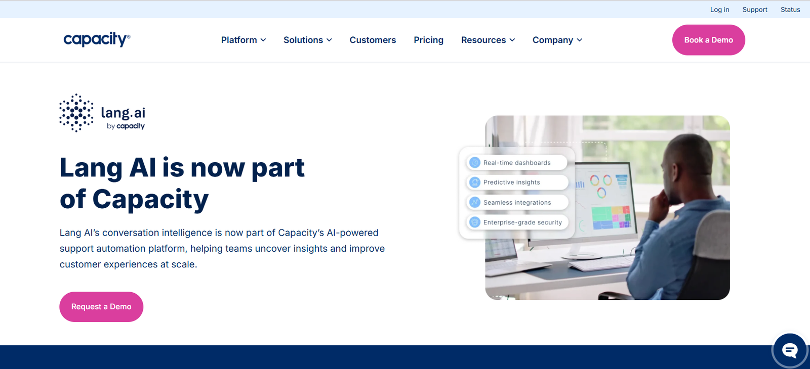 2 - Announcement that Lang AI is now part of Capacity; Lang AI logo on the left with a person at a computer displaying dashboards on the right in a modern web header hero.