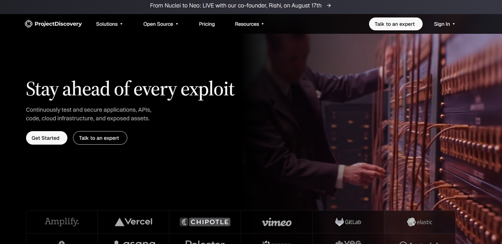 3 - Hero banner with the headline 'Stay ahead of every exploit' and two CTAs on the left, plus a technician at a server rack on the right group of images in a dark themed hero section.