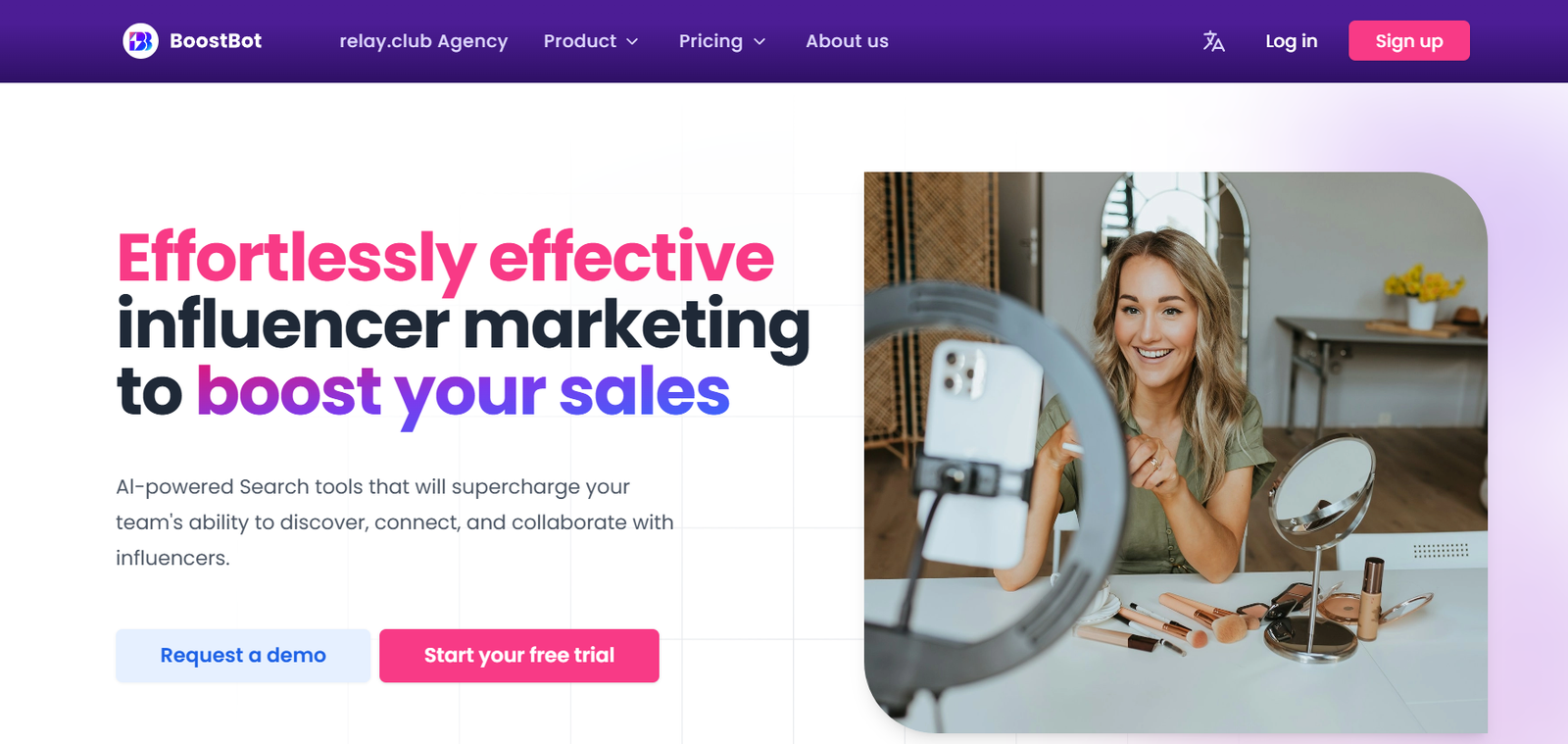 Hero banner with bold pink and dark text: 'Effortlessly effective influencer marketing to boost your sales' and a smiling woman filming herself at a makeup vanity on the right.
